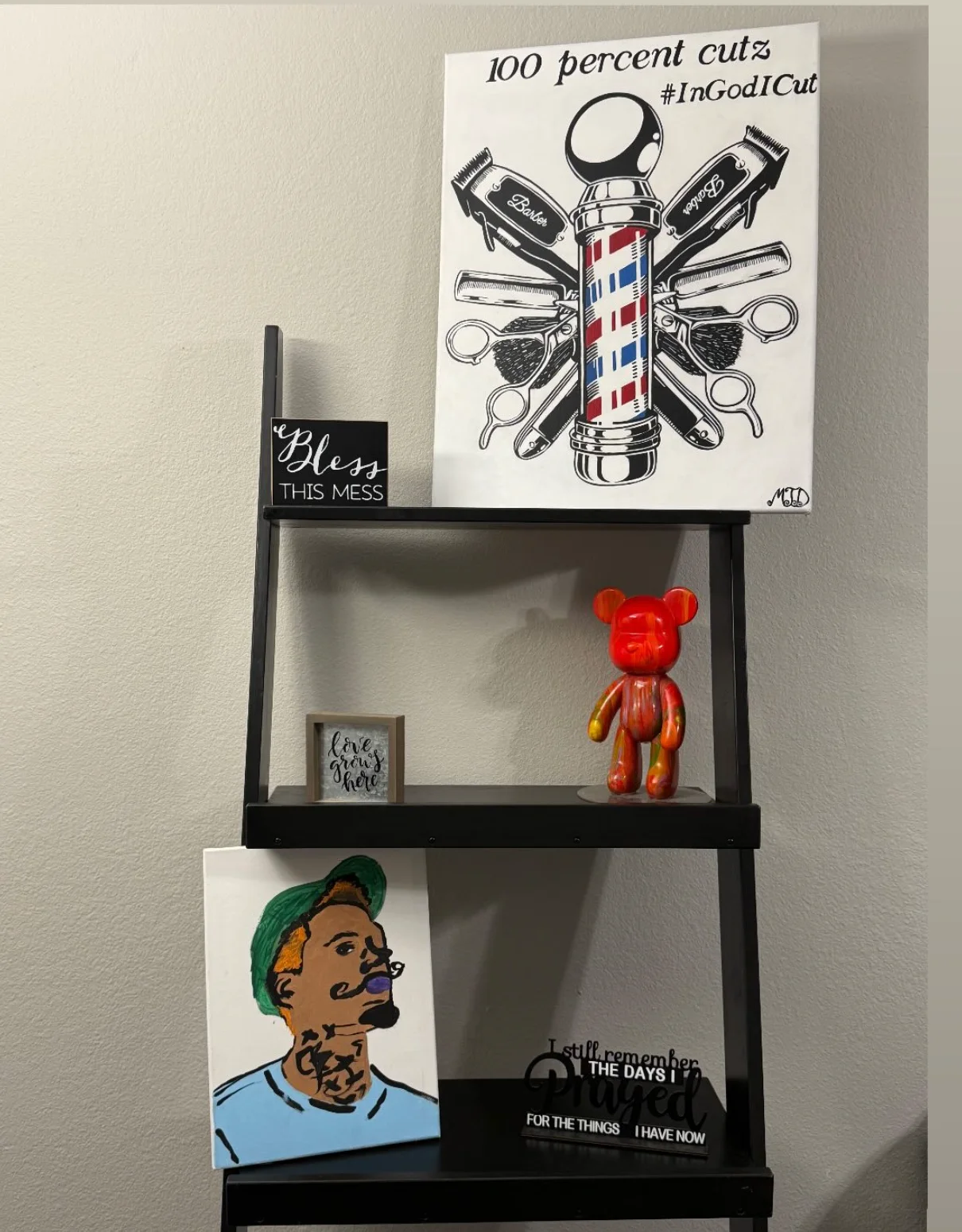 The 100 Percent Cutz sign displayed on a client's shelf