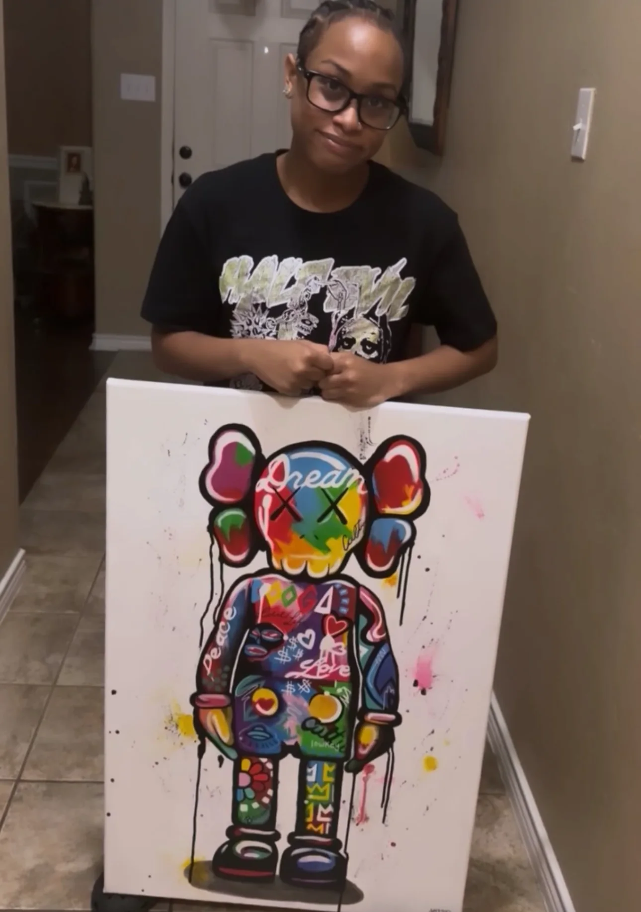 A client holding the finished Dream canvas at home