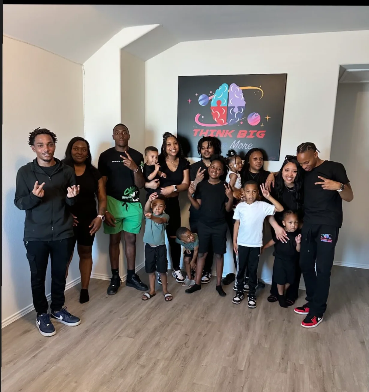 A family posing under their custom Think Big canvas