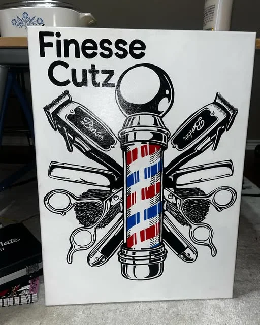 Hand-painted barbershop sign reading Finesse Cutz
